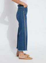 Load image into Gallery viewer, The Noah Hi Waist Crop Wide Fringe Denim is carefully crafted with two-color tobacco topstitching, a fringed hem, beltloops, back pockets, and a self-fringe insert on the side seams to provide an authentic denim look. Made from "Holding Power" Denim, this woven denim adapts to all shapes for maximum comfort and flattering fit. With a concealed patented waistband, two-way stretch, and pull-on styling, these must-have jeans are fitted through the waist and hip with a wide, cropped leg.