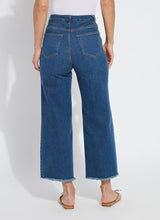 Load image into Gallery viewer, The Noah Hi Waist Crop Wide Fringe Denim is carefully crafted with two-color tobacco topstitching, a fringed hem, beltloops, back pockets, and a self-fringe insert on the side seams to provide an authentic denim look. Made from "Holding Power" Denim, this woven denim adapts to all shapes for maximum comfort and flattering fit. With a concealed patented waistband, two-way stretch, and pull-on styling, these must-have jeans are fitted through the waist and hip with a wide, cropped leg.