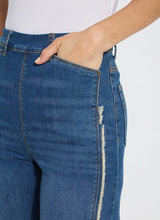 Load image into Gallery viewer, The Noah Hi Waist Crop Wide Fringe Denim is carefully crafted with two-color tobacco topstitching, a fringed hem, beltloops, back pockets, and a self-fringe insert on the side seams to provide an authentic denim look. Made from "Holding Power" Denim, this woven denim adapts to all shapes for maximum comfort and flattering fit. With a concealed patented waistband, two-way stretch, and pull-on styling, these must-have jeans are fitted through the waist and hip with a wide, cropped leg.