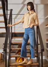 Load image into Gallery viewer, The Noah Hi Waist Crop Wide Fringe Denim is carefully crafted with two-color tobacco topstitching, a fringed hem, beltloops, back pockets, and a self-fringe insert on the side seams to provide an authentic denim look. Made from "Holding Power" Denim, this woven denim adapts to all shapes for maximum comfort and flattering fit. With a concealed patented waistband, two-way stretch, and pull-on styling, these must-have jeans are fitted through the waist and hip with a wide, cropped leg.