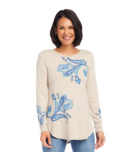 Load image into Gallery viewer, Elevate your wardrobe with this exquisite paisley-printed top that effortlessly combines classic elegance with a modern twist. The intricate paisley pattern is a timeless design that adds a touch of sophistication to your look. Color- Oatmeal and blue. Length: 26 3/4 inches (size M). Scoop neckline. Long sleeves. Shirttail hem. Fabric -Yarn Dye Jersey: 95% Viscose, 5% Spandex