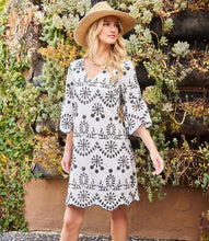 Load image into Gallery viewer, Experience the enchanting charm of this embroidered dress and unleash your inner bohemian spirit. Capturing the essence of effortless sophistication, this dress includes a gentle lining to preserve the integrity of the design and intricate eyelet accents that exude a feeling of uninhibited self-assurance.