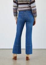 Load image into Gallery viewer, Woman wearing blue jeans, a patterned sweater and tan suede boots against a white background.