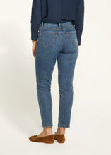 Load image into Gallery viewer, Expertly crafted with a nod to floral fashion, these Olivia Pencil Ankle Denim in Medium Wash, project understated chic. Delicate flower embellishments adorn the outer side of each leg, adding a distinct touch. The classic pencil cut flatters the figure and offers a sleek and modern silhouette.