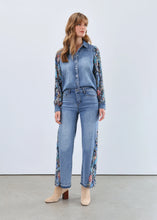 Load image into Gallery viewer, Woman in denim shacket with floral sleeves, jeans with floral side inserts and tan boots against a white background.