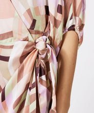 Load image into Gallery viewer, A captivating composition of color and pattern culminate in a simply stunning dress. Our Gena features a timeless silhouette paired with a geometric print to create a flattering, dynamic look. Completed with three quarter, billowy, elasticized sleeves and a side tie. Colors- Brown, pink, lilac, mint green. Collared. Wrap style dress. Billowy three quarter, elasticized sleeves. Side tie. Geometric print.