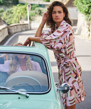 Load image into Gallery viewer, A captivating composition of color and pattern culminate in a simply stunning dress. Our Gena features a timeless silhouette paired with a geometric print to create a flattering, dynamic look. Completed with three quarter, billowy, elasticized sleeves and a side tie. Colors- Brown, pink, lilac, mint green. Collared. Wrap style dress. Billowy three quarter, elasticized sleeves. Side tie. Geometric print.