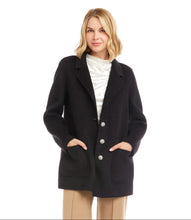 Load image into Gallery viewer, Woman wearing a black blazer with rhinestone buttons over a white top and tan pants against a white background.