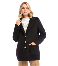 Load image into Gallery viewer, Woman wearing a black blazer with rhinestone buttons over a white top and tan pants against a white background.