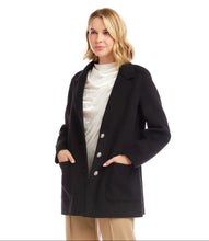 Load image into Gallery viewer, Woman wearing a black blazer with rhinestone buttons over a white top and tan pants against a white background.