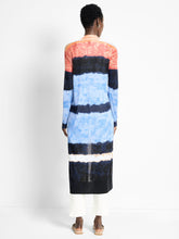 Load image into Gallery viewer, Person wearing a long, multicolored striped cardigan against a white background.