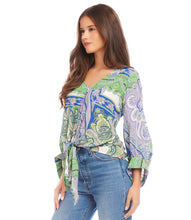 Load image into Gallery viewer, Featuring a captivating green and blue paisley print, this top effortlessly commands attention with its vibrant hues and eye-catching design. Designed with blouson sleeves and a tie-front detail, this top offers a relaxed yet chic silhouette that drapes beautifully on the body with a customizable fit.