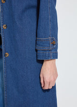 Load image into Gallery viewer, Close-up of the front buttons and sleeve of a blue denim trench coat against a white background.