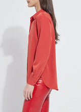 Load image into Gallery viewer, Model wearing a red blouse and red pants against a white background.