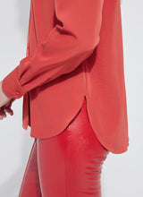 Load image into Gallery viewer, Close-up of a red blouse and red pants worn by a model against a white background.