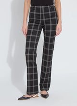 Load image into Gallery viewer, Model wearing black and off-white plaid pants and black flats standing against a white background.