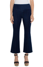 Load image into Gallery viewer, Model wearing dark blue ankle flare, pull on denim and black high heeled sandals against a white background.
