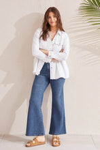Load image into Gallery viewer, A peplum design creates a waist-defining silhouette in this timeless denim jacket. We can't get enough of the stretch denim fabric, button-up shank closure, shirt collar neck that offers a structured look, opening sleeve cuffs, functional flap chest pockets, hidden side seam pockets, 28.5" length, and trendy raw hem.