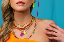 Load image into Gallery viewer, Glamorize your ensemble with the Suki Necklace! Made with premium crystals and antique gold plating on a brass base metal, it will be the highlight of any ensemble. A perfect jewelry piece to wear alone or layer with your other favorite pieces. Color- Pink, clear and gold. Pink crystal. Clear crystals. Antique gold plating over brass metal. Length -16" chain with a 2" extension.