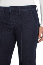 Load image into Gallery viewer, Close-up of model wearing dark blue denim trouser wit pintuck seam and white top.