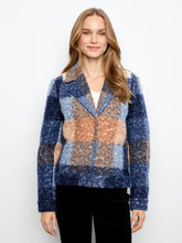 Load image into Gallery viewer, A woman modeling a boucle plaid short coat with blue, beige, and orange sections, worn over a white top and black pants against a plain white background.