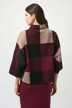 Load image into Gallery viewer, Woman wearing a burgundy, black and taupe patterned sweater and burgundy skirt against a white background.