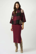 Load image into Gallery viewer, Woman wearing a burgundy, black and taupe patterned sweater, burgundy skirt and tall taupe boots against a white background.