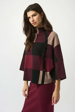 Load image into Gallery viewer, Woman wearing a burgundy, black and taupe patterned sweater and burgundy skirt against a white background.