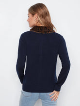 Load image into Gallery viewer, A woman shown from the back wearing a navy blue knit sweater with a brown and black patterned faux-fur collar, paired with light blue jeans, against a plain white background.