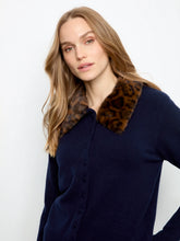 Load image into Gallery viewer, A woman wearing a navy blue knit cardigan sweater with a brown and black leopard-print faux fur collar, photographed against a clean white studio background.