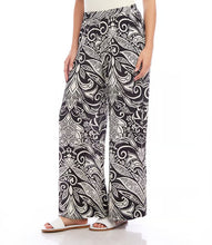 Load image into Gallery viewer, Experience the classic charm of the deco monotone print with our Print Wide Leg Pants in Black and White by Karen Kane. This refined pattern perfectly complements the wide-leg silhouette and features a flowy design and soft viscose fabric for effortless style and unrestricted movement. Elevate your wardrobe with this elegant and functional piece.
