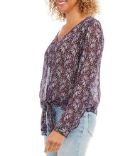 Load image into Gallery viewer, This gorgeous top is crafted with a soft crinkled knit fabric that drapes and flatters. It features a V-neckline, long cuffed sleeves, and a loose fit. Shimmering metallic threading glistens among the floral pattern and really draws the eye. The timeless tie front hemline completes the look. Color- Shades of purple and metallic. Metallic crinkled knit fabrication. V-neckline. Long cuffed sleeves. Loose fit. Tie front hemline.