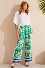 Load image into Gallery viewer, Flowy and vibrant, these printed pants feature a wide leg design and lush botanical print. They're designed with a 30'' inseam, drawstring waist, and convenient side pockets. Pair with a basic white shirt or tee and your favorite sandals and you will be ready to face the day in style.