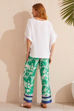 Load image into Gallery viewer, Flowy and vibrant, these printed pants feature a wide leg design and lush botanical print. They're designed with a 30'' inseam, drawstring waist, and convenient side pockets. Pair with a basic white shirt or tee and your favorite sandals and you will be ready to face the day in style.