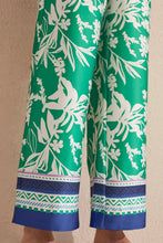 Load image into Gallery viewer, Flowy and vibrant, these printed pants feature a wide leg design and lush botanical print. They're designed with a 30'' inseam, drawstring waist, and convenient side pockets. Pair with a basic white shirt or tee and your favorite sandals and you will be ready to face the day in style.