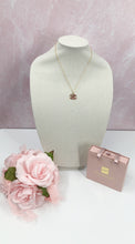 Load image into Gallery viewer, Stunning sparkle describes the Prudence Pink and Gold Vintage Coco Chanel Zipper Pull Necklace. With a gold border and spectacular pink gemstones, this brilliant style will get you noticed and give you compliments. Attached is a small pink crystal to add extra sparkle which can easily be detached if desired.