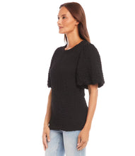 Load image into Gallery viewer, This chic top features a unique bubble texture that adds dimension and style to any outfit. The flattering puff sleeves bring a feminine charm, while the versatile black color makes it easy to dress up or down. Crafted with a soft and stretchy fabric blend, it offers both comfort and sophistication for any occasion.