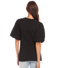 Load image into Gallery viewer, This chic top features a unique bubble texture that adds dimension and style to any outfit. The flattering puff sleeves bring a feminine charm, while the versatile black color makes it easy to dress up or down. Crafted with a soft and stretchy fabric blend, it offers both comfort and sophistication for any occasion.