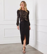 Load image into Gallery viewer, Discover our puff sleeve top, crafted from sumptuous velvet burnout knit and adorned with a chic cheetah print. The metallic foil detail infuses a hint of glamour, complemented by the contemporary twist front design. This top's elastic fabric ensures a blend of fashion and comfort.