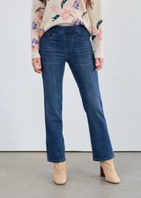 Load image into Gallery viewer, Woman wearing a floral sweater, blue jeans and beige boots against a white background.