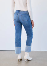 Load image into Gallery viewer, Model wearing white top, blue jeans with pearl embellished cuffs and white boots against a white wall.