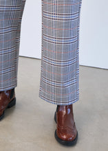 Load image into Gallery viewer, Close-up of plaid pants and brown boots against a white background.