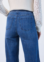 Load image into Gallery viewer, Model wearing blue and silver check wide legs jeans and white lace top against a white background.