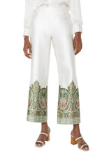 Load image into Gallery viewer, The Liverpool Los Angeles Pull-On Wide Leg Pants in Cream Olive Paisley are a stylish and comfortable addition to your wardrobe. Featuring a unique paisley print, these pants are designed with a mid-rise elastic waistband and a tie front for a secure and adjustable fit. The wide-leg cropped silhouette and slant front pockets add a touch of practicality and elegance. Crafted from lightweight woven fabric, these pants, with a satiny feel, are perfect for pairing with the matching halter top or blouse.