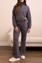 Load image into Gallery viewer, Woman wearing a gray casual zip up top, matching gray jogger and sneakers standing in a room with a beige couch.