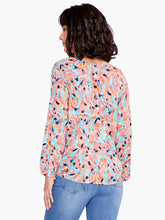 Load image into Gallery viewer, Take a peek at your new favorite colorful top for dressing up or down. Beautiful spring/summer colors pop on this fabulous top includes a keyhole negative space detail that draws the eye. An easy fitting round neck top with 3/4 elastic cuff sleeves complete the look. Designed to sit slightly below the hip. Colors- Blues, orange, coral, pink, black. Easy fit. Round neck. 3/4 sleeve. Bishop sleeve.