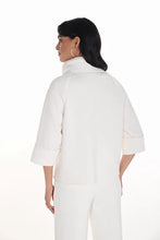 Load image into Gallery viewer, Woman wearing a white swing jacket and white pants against a white background.