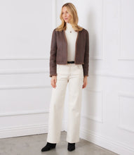 Load image into Gallery viewer, Woman wearing a brown fur coat, white turtleneck, white jeans and black boots against a white wall.