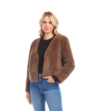 Load image into Gallery viewer, Woman wearing a brown fur jacket over a black top and blue jeans against a white background.