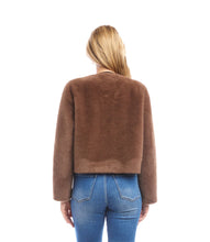 Load image into Gallery viewer, Woman wearing a brown fur jacket and blue jeans against a white background.